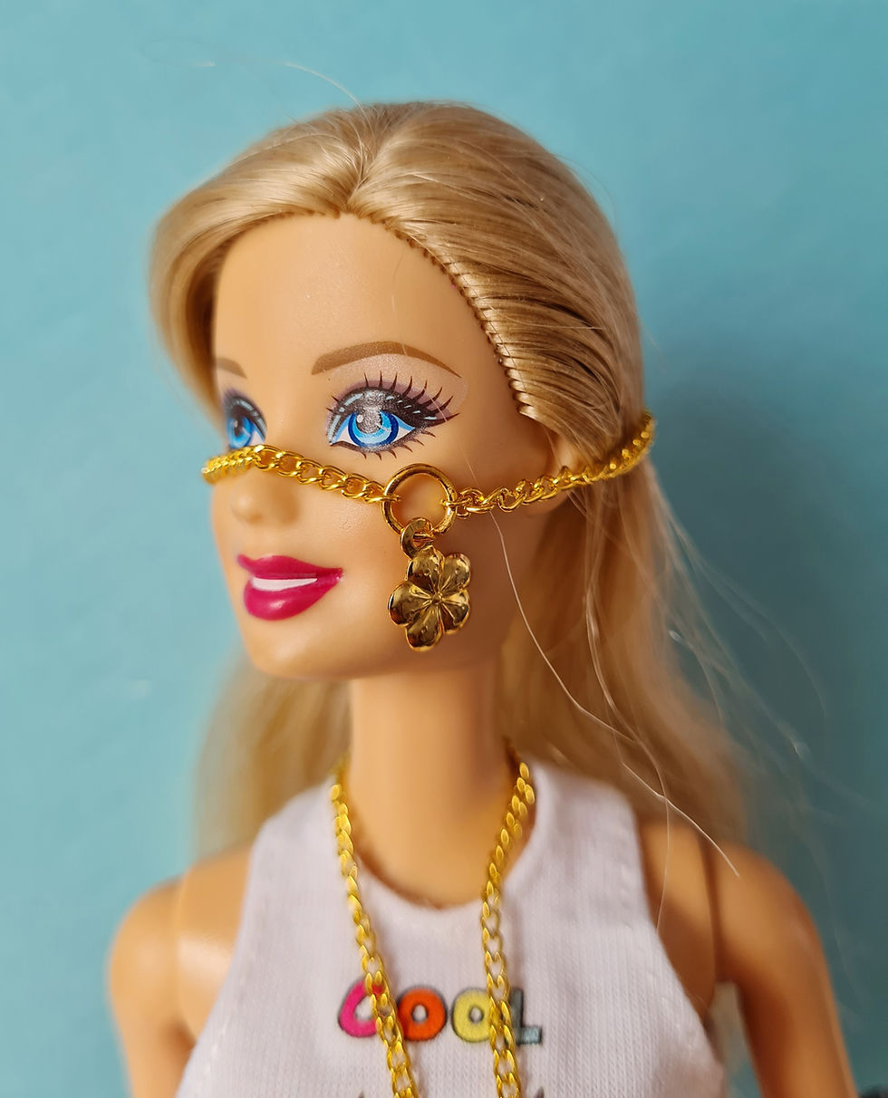 Thumbnail: Barbie modelling a Gold Chain Necklace with a gold flower or a gold star