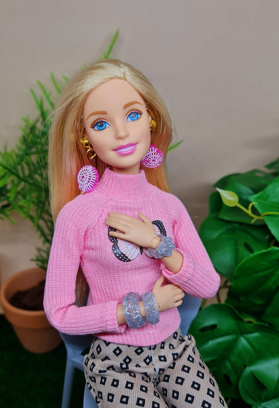 Thumbnail: Barbie is modelling a range of our Oceanic earrings in shell style