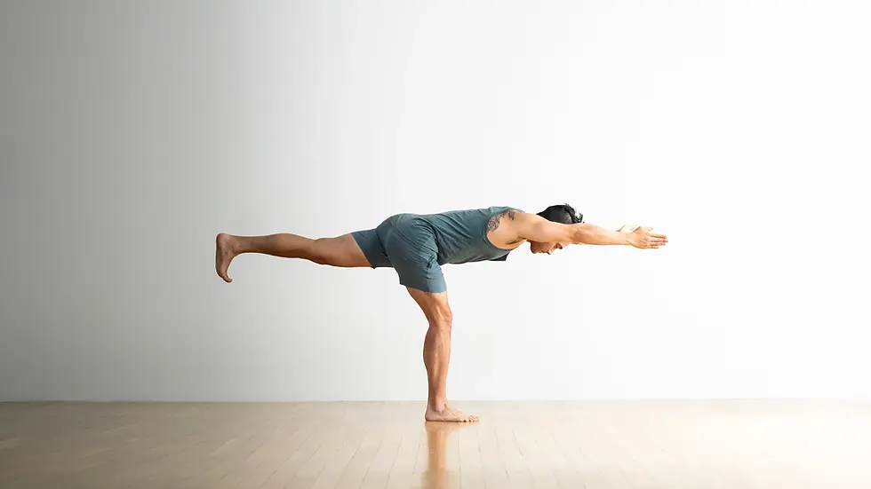 Man doing Warrior III yoga pose