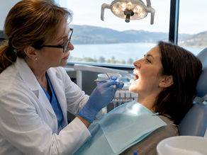 Dentist examining patient's teeth for sensitivity