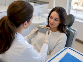 Dentist and patient reviewing whitening shade results