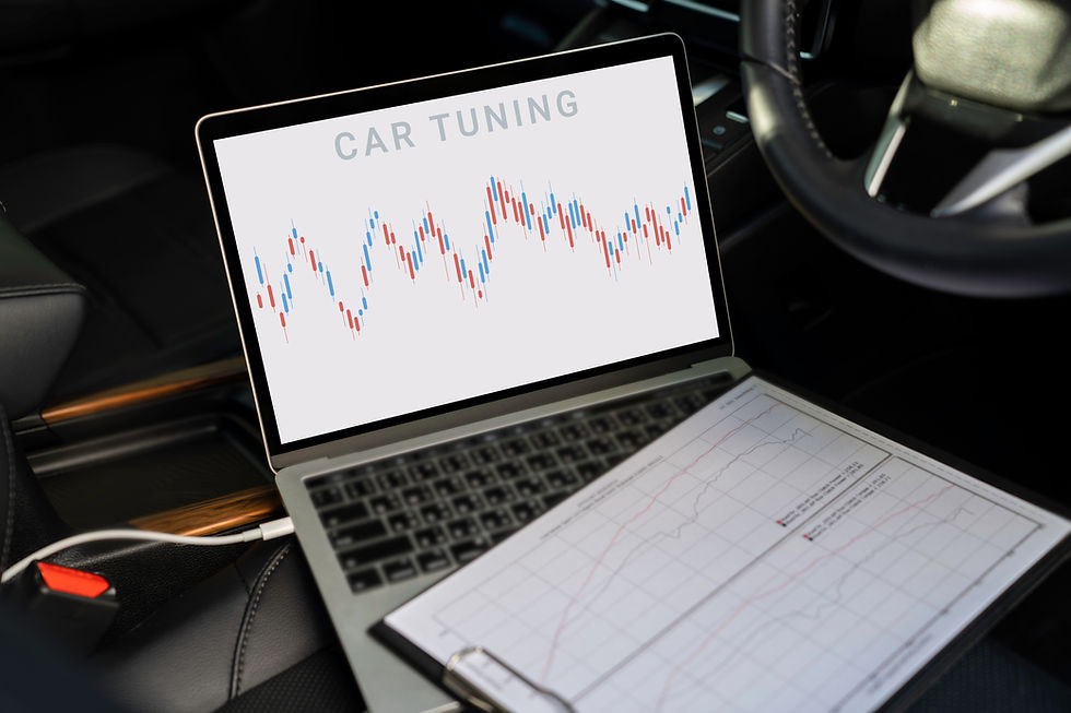 Mechanic connecting diagnostic laptop to prestige car engine for ECU remapping in Cambourne, Cambridge.