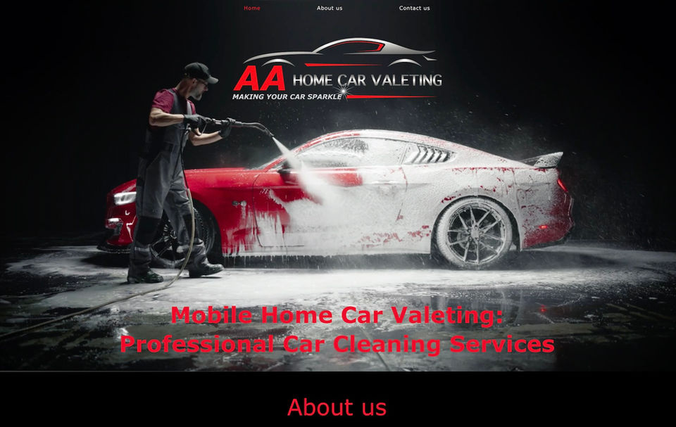 Image of AA Home Car Valeting website’s homepage showing their logo which is the letters AA in red with an image of a car in silver and red with the business name in silver underneath, on top of a video playing of a man jet cleaning a beautiful red sports car. AA Home Car Valeting - logo, branding, website created, designed and managed by bluebottlewebdesign.com