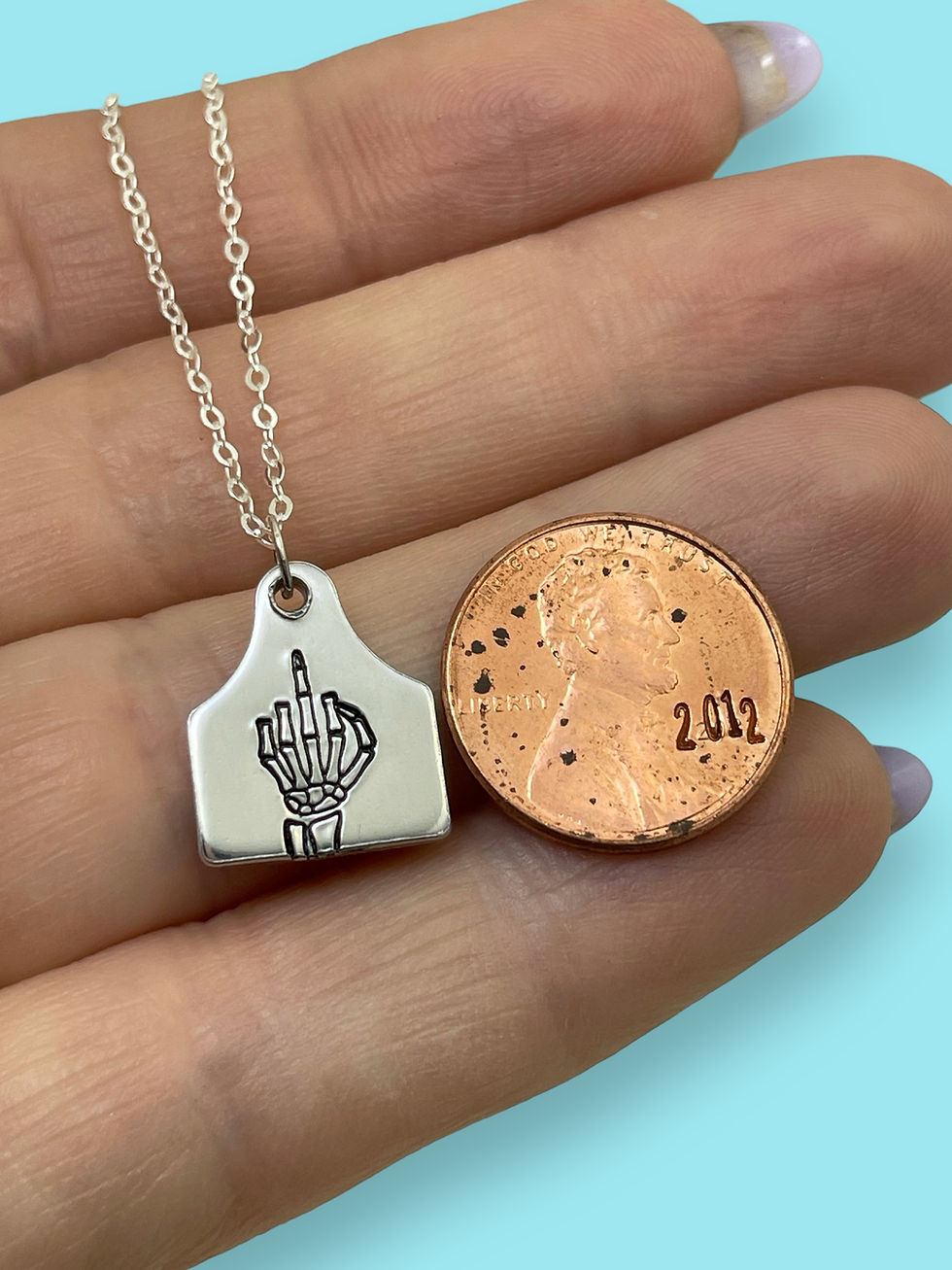 Thumbnail: silver skeleton middle finger tiny cattle tag necklace on sterling silver chain
