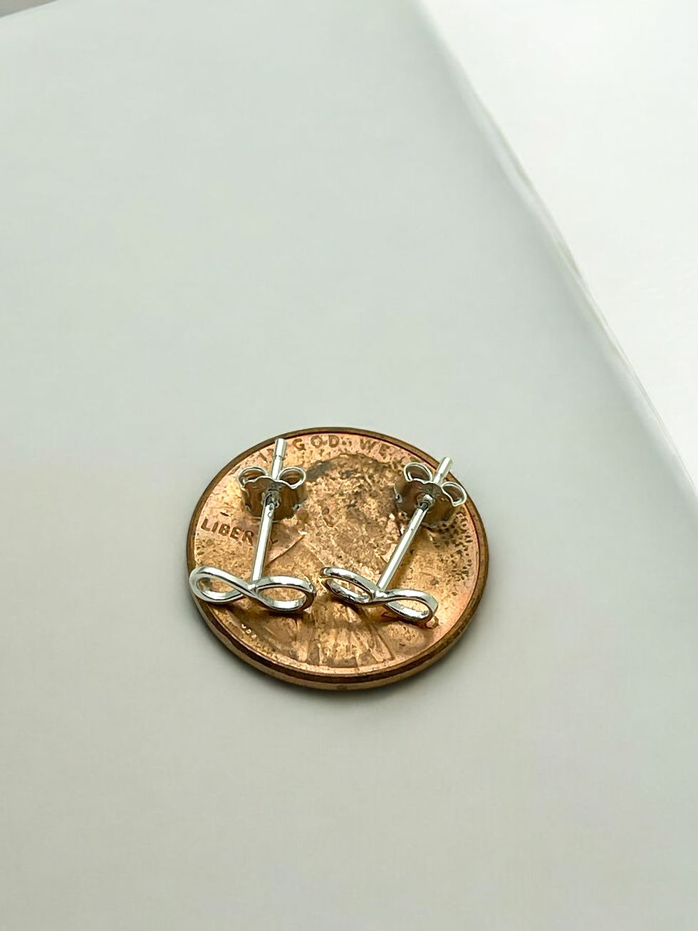 Thumbnail: Dainty, minimalist in style, .925 sterling silver infinity shaped stud earrings