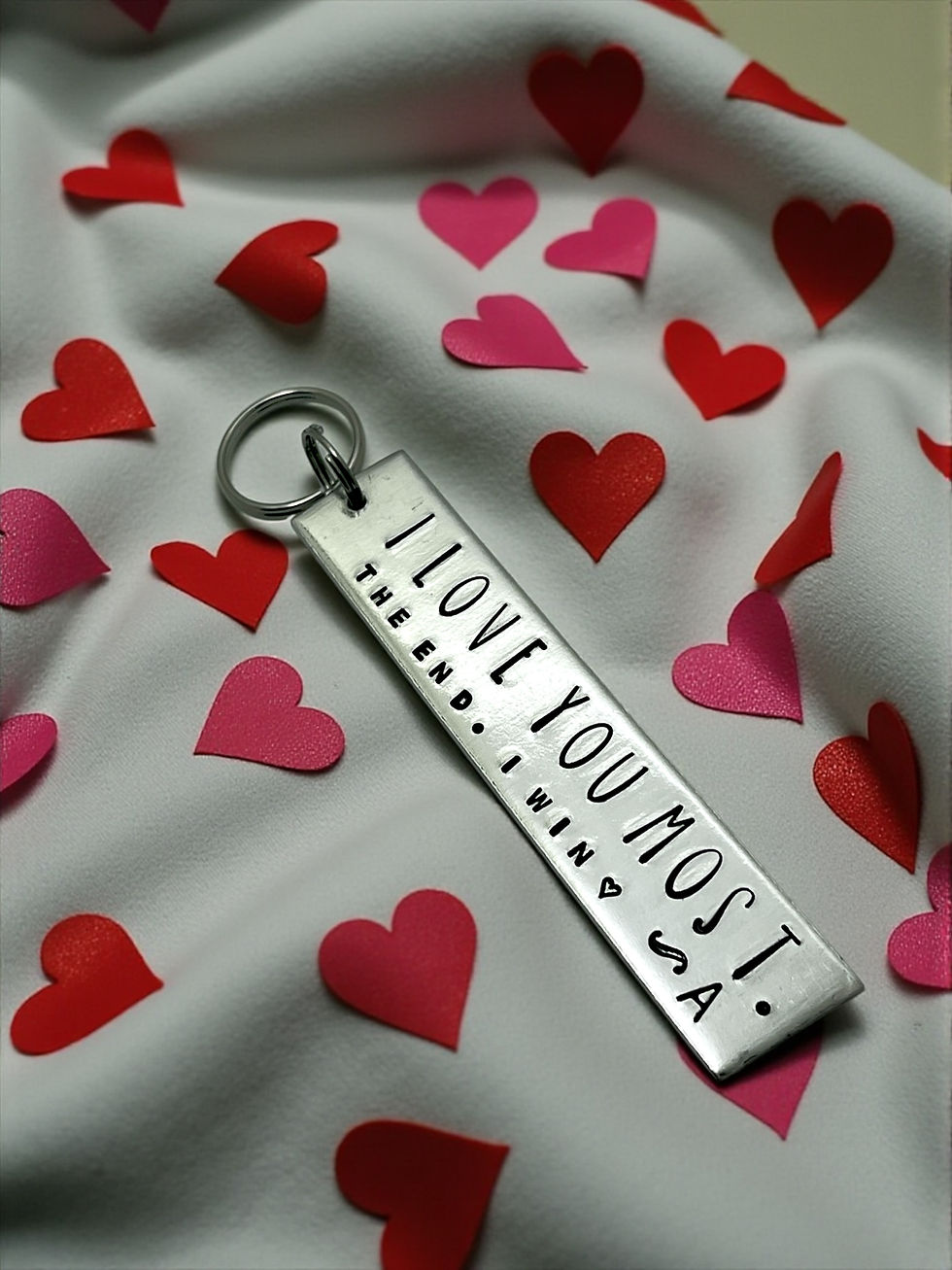 Hand stamped aluminum keychain reading I love you most the end I win with personalized initial A
