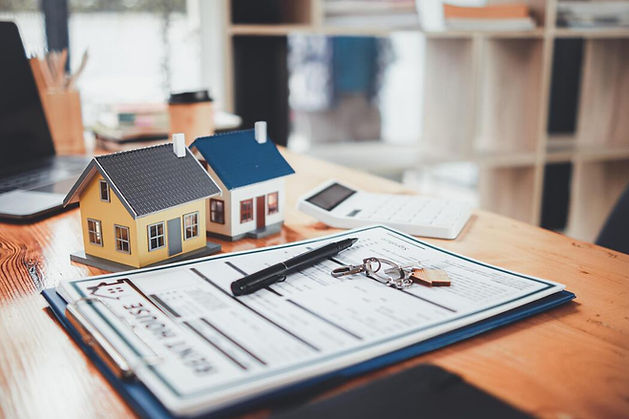 real-estate-sales-documents-and-model-homes-are-placed-on-tables-inside-real-estate-sales-
