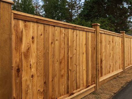 A close-up of a wooden fence with a wooden post and rail, highlighting the craftsmanship and rustic appearance.