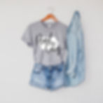 Flat lay of Pearl City Iowa State Shirt with hand-lettered design inside Iowa state outline, styled with denim shirt