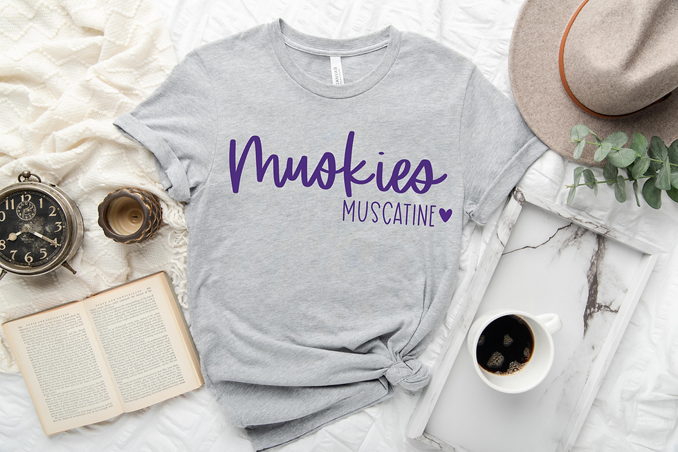 Thumbnail: Soft gray Muscatine Muskies t-shirt by Letters from Elliott, styled with coffee and a book.