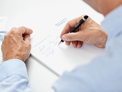 Man writing on checked paper