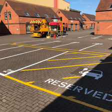 Parking area with designated spaces for EV charging