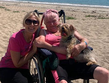 client and carer at the beach