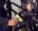 Midsection of man locking bicycle in city