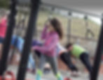 girl playing on outdoor gym equipment