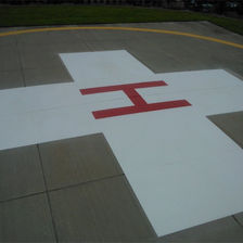 H in a white cross on the ground