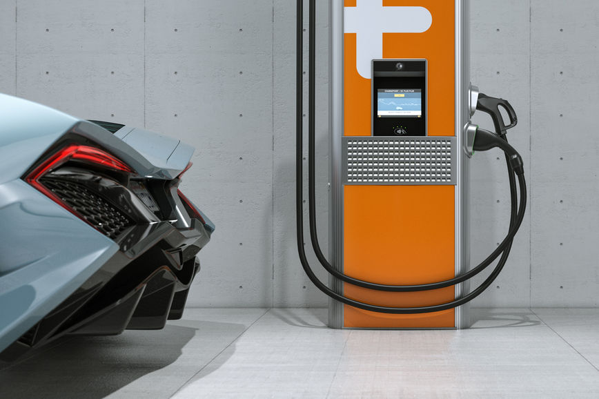 Silver concept car parked beside a ChargePoint Express Plus charging station