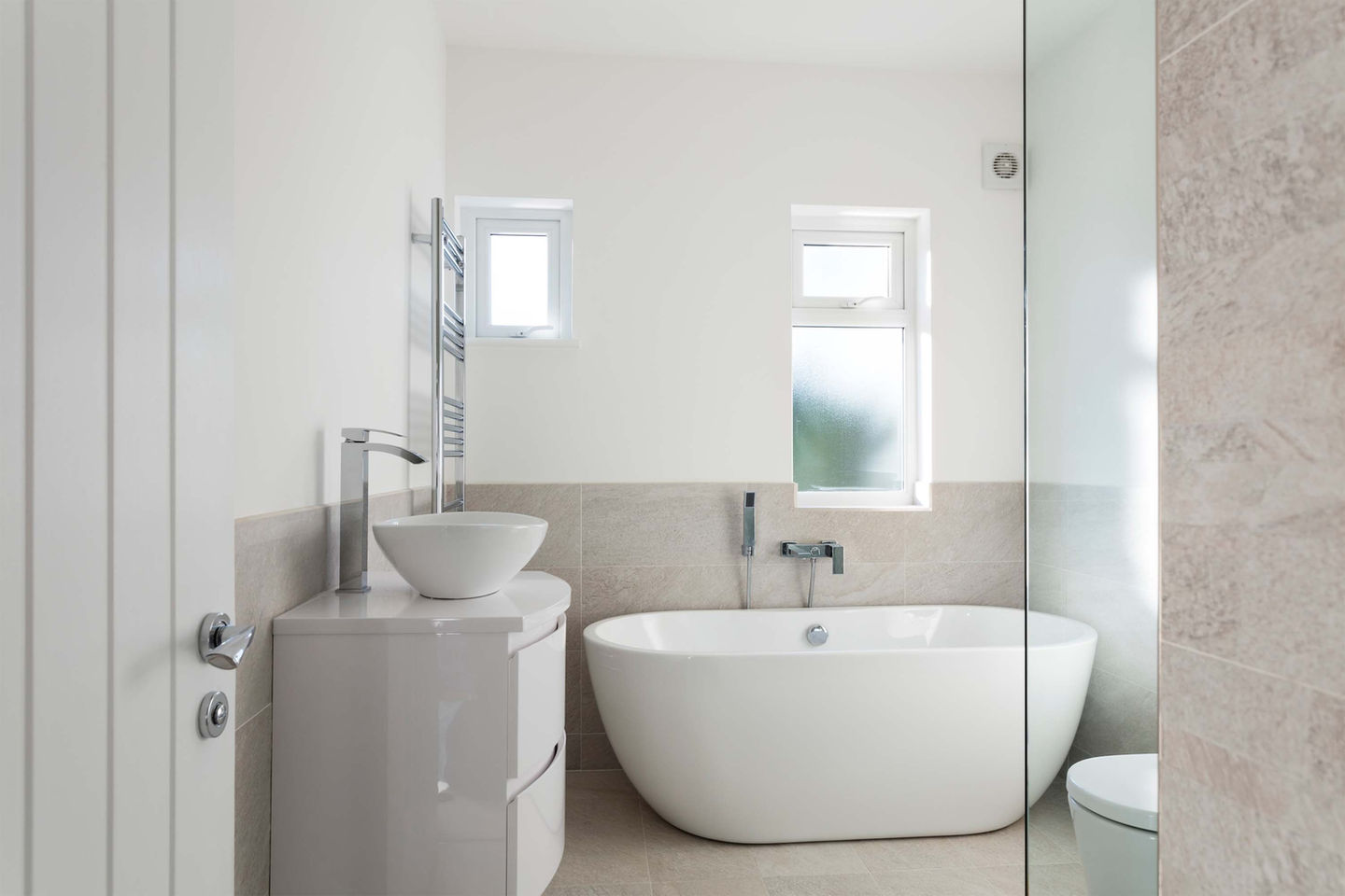 Modern family bathroom with standalone ceramic tub.