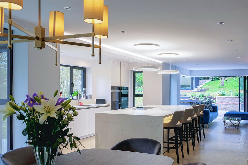 Large modern kitchen in wjote with stone tiling and large island / breakfas bar.