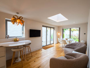 Modern kitchen /. living space, full height sliding doors with roof light