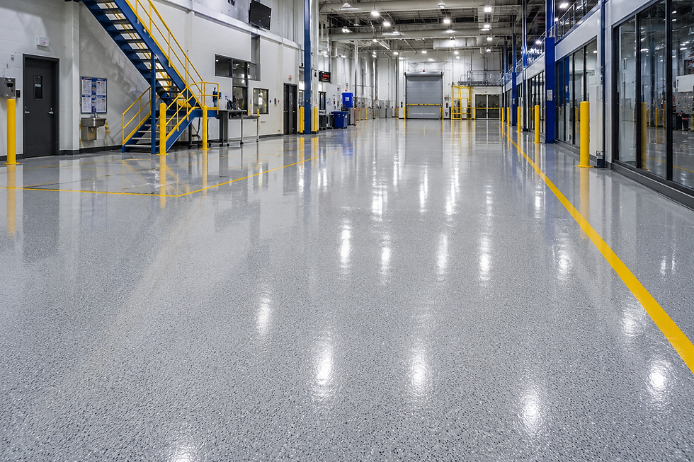 Shiny grey epoxy flooring with yellow lines in industrial space