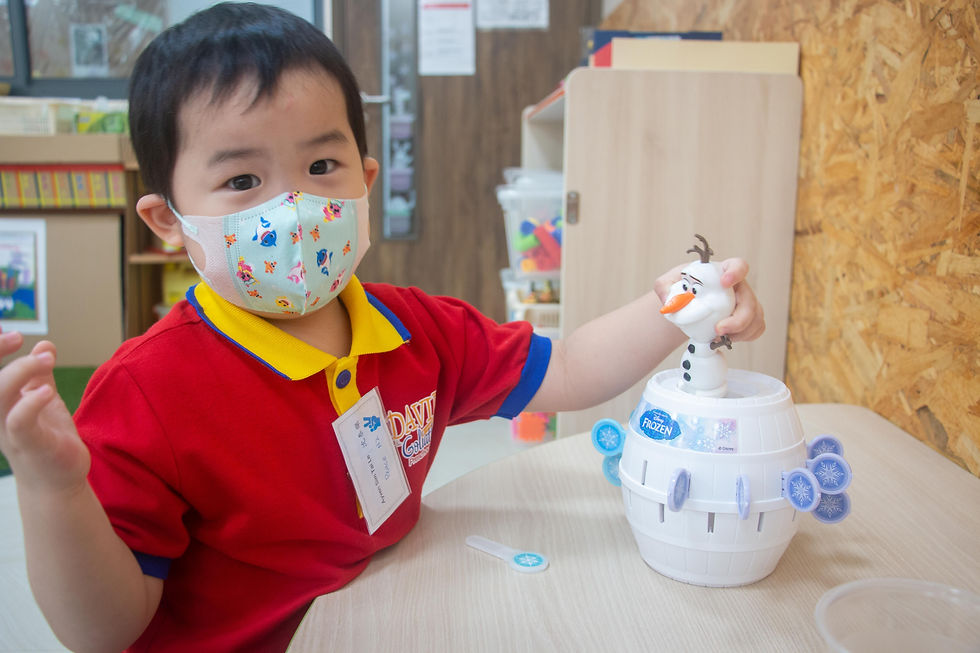 A DGP student playing with toys in Creative Play Space