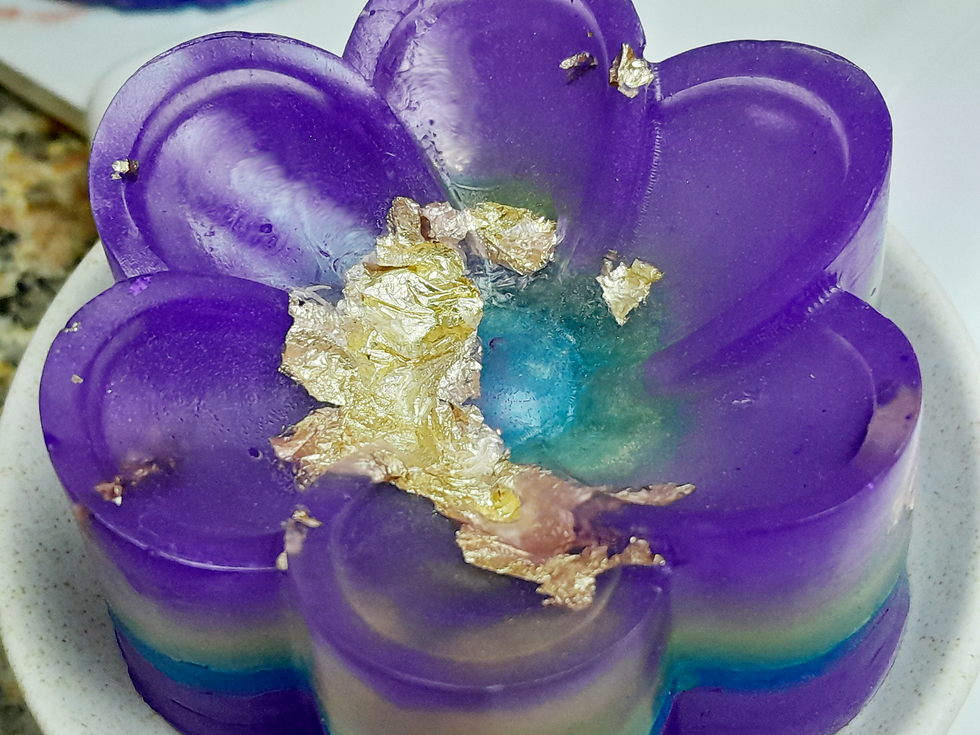 Thumbnail: frangipani-shaped soap bar (80g) with multiple shades of mica glitter and shiny copper flakes - close up