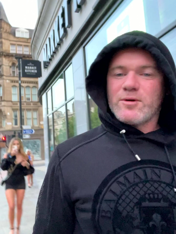 Wayne Rooney filmed with two blondes as he walked back to budget hotel with the young women