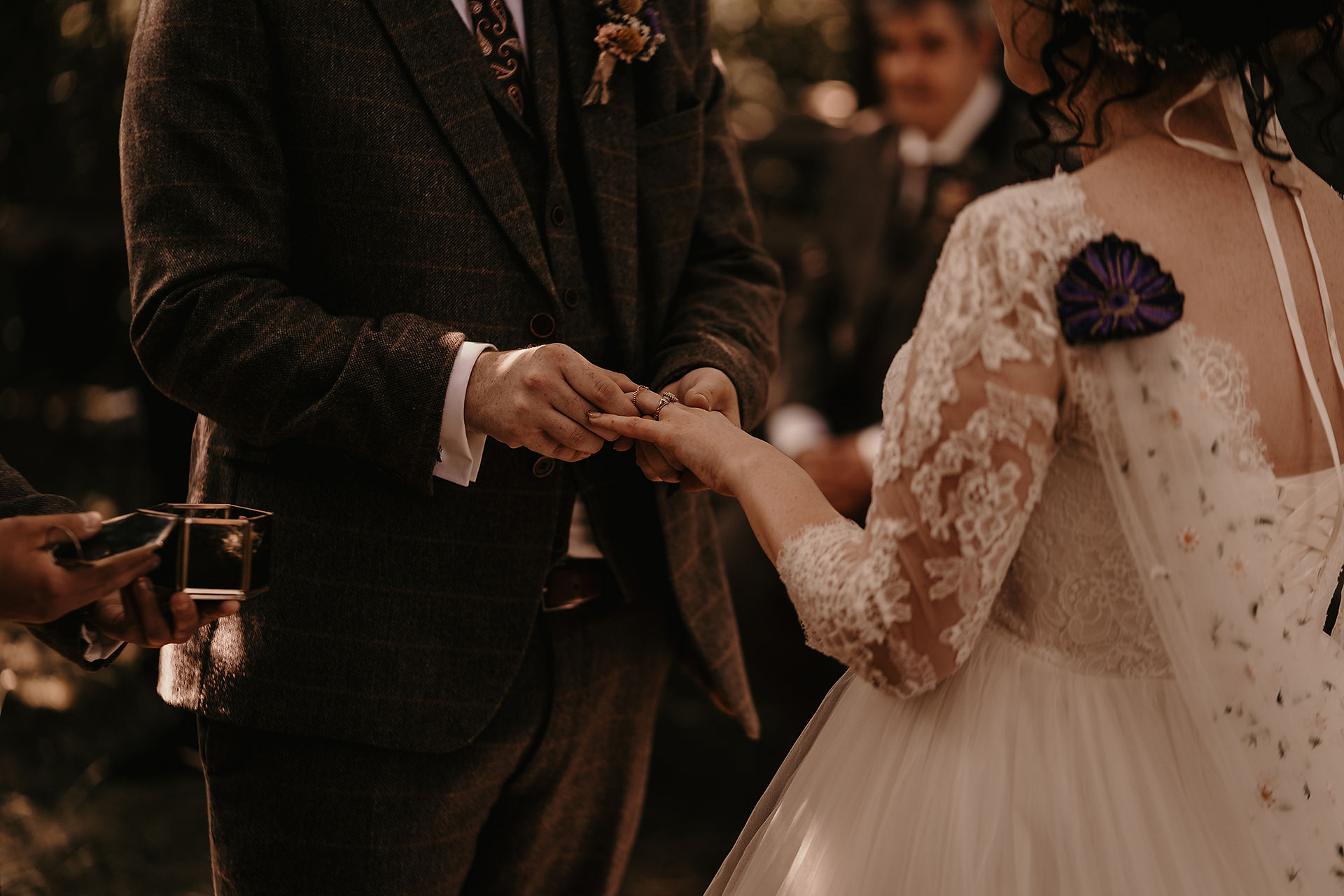 alternative bride exchanging rings during alternative woodland ceremony