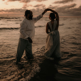 Playful couple dancing in the ocean the night before their wedding in Barcelona
