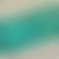 A partial view of a sheet of USPS postal sticker-stamps on a linen surface. The same rendering of a manatee and small fish in water is pictured on each teal blue stamp. The word MANATEE is printed at the bottom of each stamp.