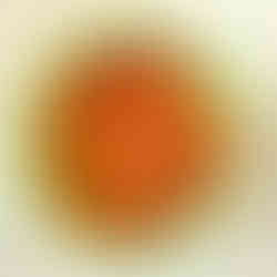 A light green bowl filled with candy corn