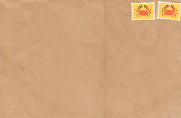 Creased brown kraft paper envelope with two yellow stamps — each with an orange crab — positioned in the upper right corner