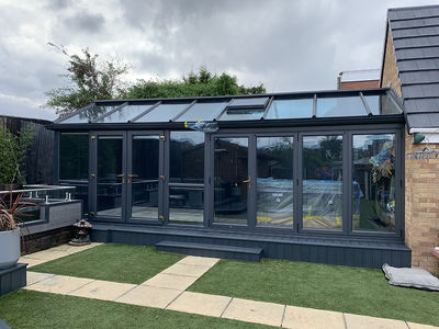 A large glass conservatory which has been professionally UPVC spray painted by Ultra Spray.