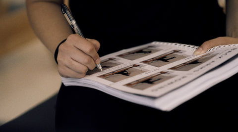 Close-up of instructor writing course notes