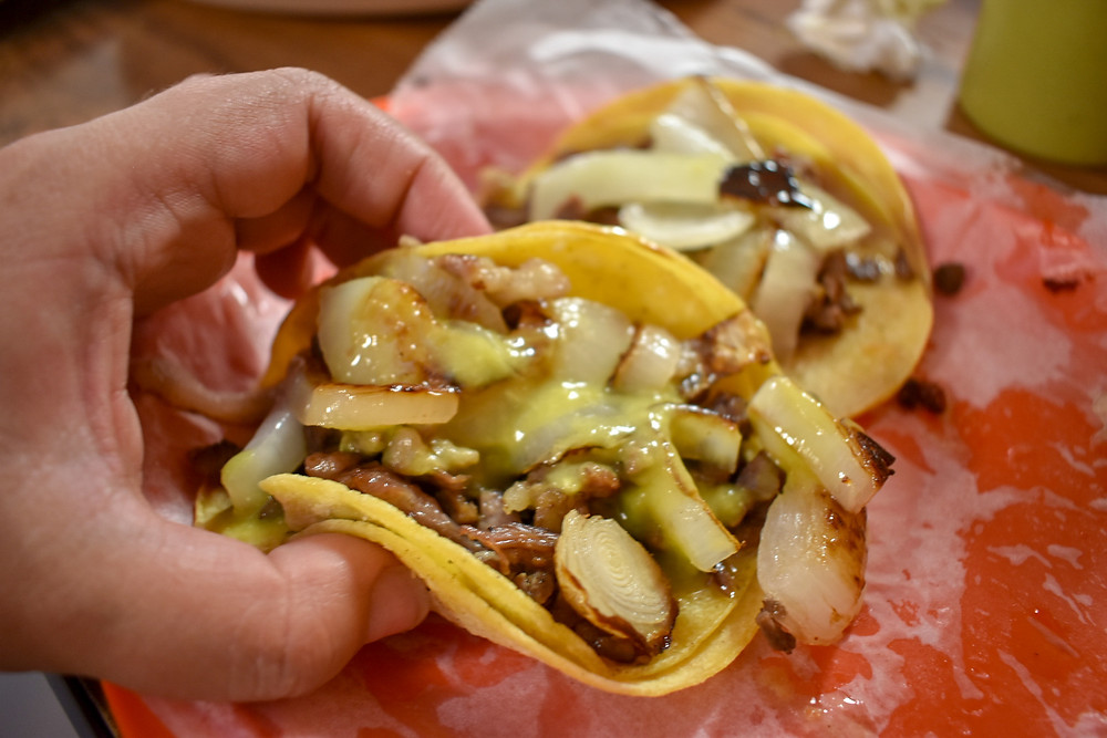 Tacos de carne asada topped with grilled onions at Taqueria Monterrey Chiquito in Houston, Texas