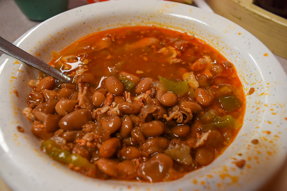 Frijoles Charros served with tacos at Taqueria Puro Jalisco in Pasadena, Texas