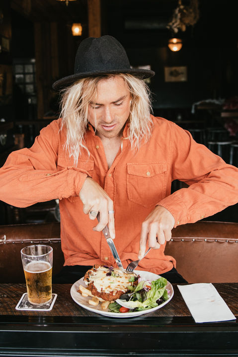 Guest eating a delicious chicken parma.
