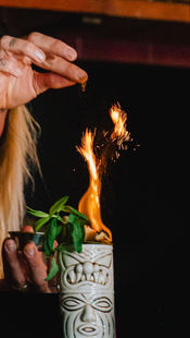 Tiki cocktail with sizzling flame.