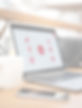 A workspace with an open laptop displaying a Sentinel|9 educational slide, next to a smartphone.
