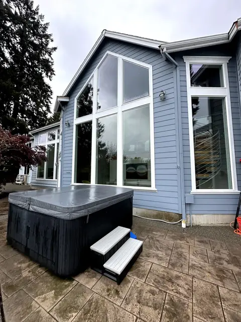 glass windows on the outside of a house next to a sauna