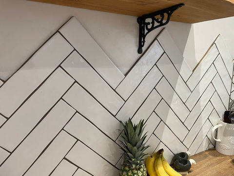 Newly installed kitchen wall tiles with some fruits on the countertop