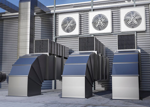 Large metal ventilation ducts and extraction fans installed on the side of a building