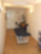A therapy room featuring a massage table
