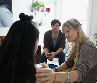 A woman comforting another woman in a counselling