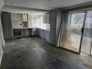 A room with a kitchen with grey cabinets after clearance