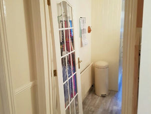 Glazed hallway door fitted near a storage cupboard