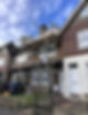 A house with white windows and scaffolding erectors