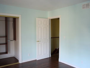 White panelled door fitted in a hallway with wooden flooring