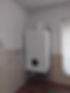 A modern wall-mounted gas boiler installed in the kitchen